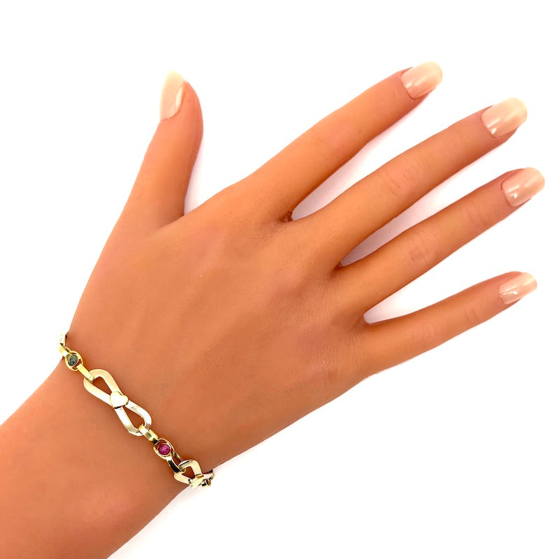 Bracciale catena fiocchi oro bicolore, zaffiri e rubini; 4.12 gr - 19.5 cm