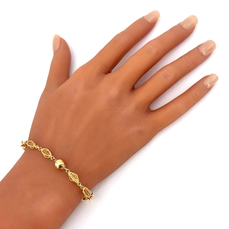 Bracciale catena palline e motivo corde oro; 6.65 gr - 17 cm