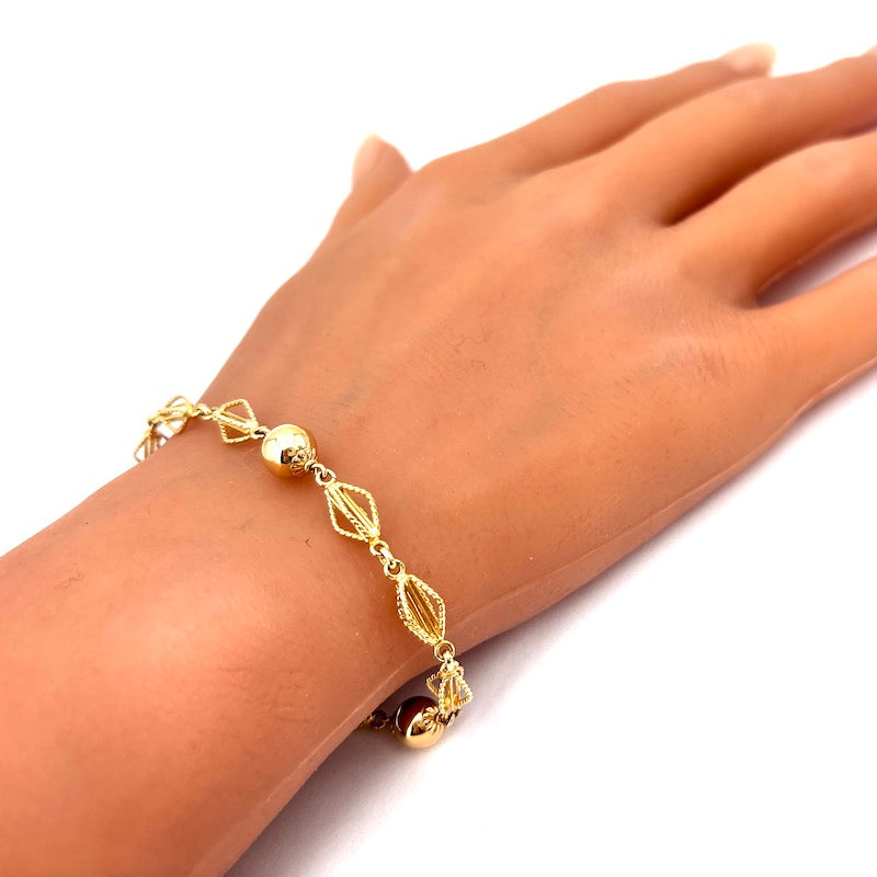 Bracciale catena palline e motivo corde oro; 6.65 gr - 17 cm
