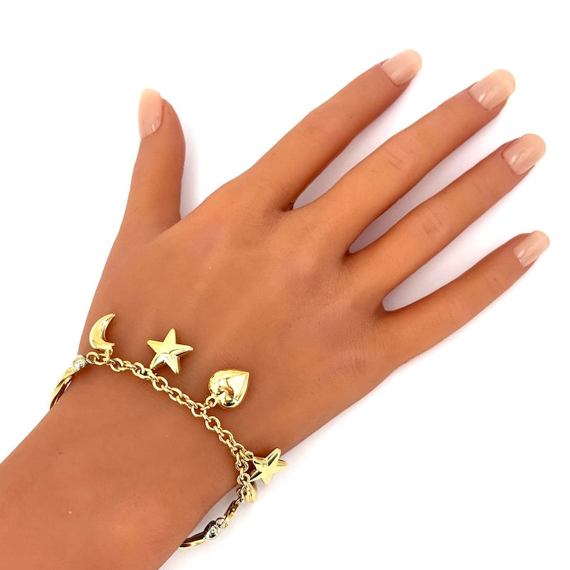 Bracciale semirigido con charms stelle, lune e cuore, oro giallo; 12.8 gr